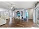 Open concept living area with tile floors, white couches, decorative columns, and a built-in entertainment center at 9826 La Vonda St, Riverview, FL 33569