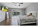 Bedroom features wood floors, sliding door access to the pool area at 9826 La Vonda St, Riverview, FL 33569