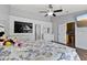 Cozy bedroom features wood floors, ceiling fan, and modern design elements at 9826 La Vonda St, Riverview, FL 33569
