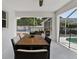 Covered patio with ceiling fan, table, and view of pool and backyard at 9826 La Vonda St, Riverview, FL 33569