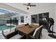 Covered patio with dining table and chairs that overlooks the pool at 9826 La Vonda St, Riverview, FL 33569