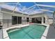 Enclosed pool area with a clear blue pool and covered patio at 9826 La Vonda St, Riverview, FL 33569
