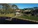 Aerial view showcasing lush landscaping, a gazebo, and a private dock on the calm water at 10411 Cory Lake Dr, Tampa, FL 33647