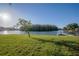Waterfront backyard featuring a well-manicured lawn and a private dock for enjoying the serene lake views at 10411 Cory Lake Dr, Tampa, FL 33647