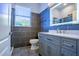 Modern bathroom features sleek gray tiles, a lighted mirror, and contemporary fixtures at 10411 Cory Lake Dr, Tampa, FL 33647