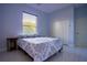Cozy bedroom with light blue walls, a large window, and neutral-toned furnishings at 10411 Cory Lake Dr, Tampa, FL 33647