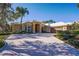 Stunning single-Gathering home with a beautiful brick driveway, lush landscaping, and a well-manicured lawn at 10411 Cory Lake Dr, Tampa, FL 33647
