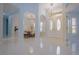Beautiful foyer featuring double doors and tiled flooring leading to the dining room and another room at 10411 Cory Lake Dr, Tampa, FL 33647