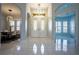 Bright foyer featuring large double doors with decorative glass and complemented by tile flooring at 10411 Cory Lake Dr, Tampa, FL 33647