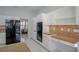 Kitchen featuring white cabinets, granite countertops, and black appliances at 10411 Cory Lake Dr, Tampa, FL 33647