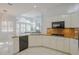 Bright kitchen with granite countertops, white cabinets, and views into the spacious living room with lots of natural light at 10411 Cory Lake Dr, Tampa, FL 33647
