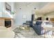 Large living room with high ceilings, modern decor, fireplace, and adjacent kitchen perfect for entertaining at 10411 Cory Lake Dr, Tampa, FL 33647