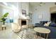 Sunlit living room featuring a cozy fireplace, plush seating, and an open layout bathed in natural light at 10411 Cory Lake Dr, Tampa, FL 33647