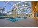 Refreshing pool with spa inside a screened enclosure, offering serene outdoor enjoyment at 10411 Cory Lake Dr, Tampa, FL 33647