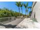 Wooden back deck featuring a seating area and lush green landscaping at 10408 Double Bayou Way, Tampa, FL 33615