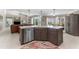 Modern kitchen island with a sink, stainless steel appliances, and a view to the Gathering room at 10408 Double Bayou Way, Tampa, FL 33615