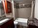 Bathroom featuring updated fixtures, tiled shower and tub at 105 S Obrien St # 216, Tampa, FL 33609