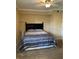 Bedroom featuring a comfortable queen-size bed and carpeted floor at 105 S Obrien St # 216, Tampa, FL 33609