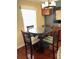 Dining area with glass table and wood chairs, lit by an elegant chandelier and a bright window at 105 S Obrien St # 216, Tampa, FL 33609