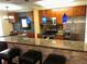 View of kitchen featuring bar, modern appliances, stone countertops, and backsplash at 105 S Obrien St # 216, Tampa, FL 33609