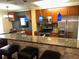 Modern kitchen with granite counters, stainless steel appliances, and stylish blue pendant lighting at 105 S Obrien St # 216, Tampa, FL 33609