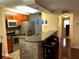 Open kitchen layout with stainless steel appliances, breakfast bar, and modern light fixtures at 105 S Obrien St # 216, Tampa, FL 33609