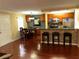 Open kitchen/dining area featuring a breakfast bar with stone accents, stainless steel appliances, and wood floors at 105 S Obrien St # 216, Tampa, FL 33609