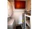 Utility room with washer, dryer, water heater, upper storage cabinet and shelving at 105 S Obrien St # 216, Tampa, FL 33609