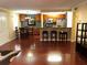 Open-concept living room and kitchen with stainless steel appliances, granite countertops, and hard wood floors at 105 S Obrien St # 216, Tampa, FL 33609