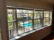 Window view showcasing the community pool, surrounded by lush greenery and lounge chairs at 105 S Obrien St # 216, Tampa, FL 33609