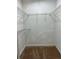 Interior shot of a well-organized walk-in closet with wire shelving and carpeted flooring at 105 S Obrien St # 216, Tampa, FL 33609