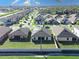 Aerial view of a residential neighborhood highlighting the well-maintained homes and community layout with green lawns at 1107 Brenton Leaf Dr, Ruskin, FL 33570