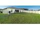 Expansive backyard featuring a well-maintained lawn, privacy fencing, and a patio area, great for outdoor activities at 1107 Brenton Leaf Dr, Ruskin, FL 33570