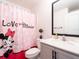 Bathroom featuring a Mickey Mouse themed shower curtain, with a light vanity and ample space at 1107 Brenton Leaf Dr, Ruskin, FL 33570