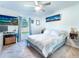 Comfortable bedroom features neutral carpet and a ceiling fan, enhanced with a large window and natural light at 1107 Brenton Leaf Dr, Ruskin, FL 33570
