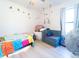 Eclectic bedroom featuring playful design elements, a colorful bedspread, and a cozy, inviting atmosphere at 1107 Brenton Leaf Dr, Ruskin, FL 33570
