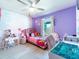 Bright bedroom with pink decor, featuring a playful design and whimsical accents, enhanced by natural light at 1107 Brenton Leaf Dr, Ruskin, FL 33570