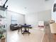A bright bonus room with a blue table set, gray couch, and tiled floors perfect for a playroom at 1107 Brenton Leaf Dr, Ruskin, FL 33570