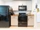 Bright kitchen featuring sleek black appliances, granite countertops, and white cabinets at 1107 Brenton Leaf Dr, Ruskin, FL 33570