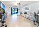 Open concept living area featuring tile floors and access to a screened lanai at 1107 Brenton Leaf Dr, Ruskin, FL 33570
