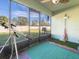 Relaxing screened patio with artificial turf, featuring views of the backyard and offering a cozy outdoor space at 1107 Brenton Leaf Dr, Ruskin, FL 33570