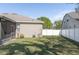 Large backyard with a privacy fence, lush lawn, and a screened patio offering a private outdoor retreat at 11749 Summer Springs Dr, Riverview, FL 33579