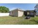 Spacious backyard featuring a mix of lush lawn, patio area, and an enclosed screened-in porch at 11749 Summer Springs Dr, Riverview, FL 33579