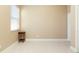 Beige empty bedroom with window blinds, baseboards, and neutral flooring at 11749 Summer Springs Dr, Riverview, FL 33579