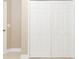 A set of white bi-fold closet doors in hallway of a neutral colored room at 11749 Summer Springs Dr, Riverview, FL 33579