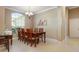 Well-lit dining area with a large window, chandelier, and seating for six at 11749 Summer Springs Dr, Riverview, FL 33579