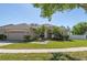 Charming single-story home boasts a well-manicured lawn, lush landscaping, and a welcoming two-car garage at 11749 Summer Springs Dr, Riverview, FL 33579