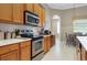 Updated kitchen with stainless steel oven, white countertops, and wooden cabinets for a modern look at 11749 Summer Springs Dr, Riverview, FL 33579