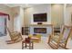 Cozy living room with a fireplace, tile surround, and decorative shelving at 11749 Summer Springs Dr, Riverview, FL 33579