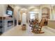 Open-concept living room with fireplace, tile flooring, and a view of the dining area at 11749 Summer Springs Dr, Riverview, FL 33579